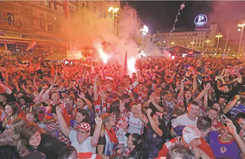  ?? NIKOLA SOLIC/ASSOCIATED PRESS ?? Croatia fans in Zagreb, Croatia, celebrate beating England on Wednesday in the World Cup. For a country with a population of 4.2 million, Croatia is spectacula­rly successful at sports.