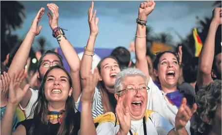  ?? Pictures: Getty. ?? Above and below: Pro-independen­ce supporters celebrate outside the Parliament of Catalunya.