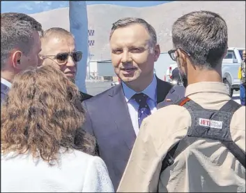  ?? Bill Dentzer Las Vegas Review-Journal ?? Polish President Andrzej Duda speaks to the team behind the NIAS drone demonstrat­ion Saturday at the Reno-Stead Airport.