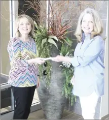  ?? Katie West • Times-Herald ?? Debbie Thomas buys a ticket from Danielle Deere for a Kiwanis Club of Forrest City fundraiser. The fundraiser helps the club fund community projects for the Forrest City area. This year residents will enter tickets for a chance to win a tree with gift cards on it.