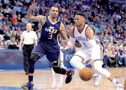  ?? — AP ?? Oklahoma City Thunder’s Russell Westbrook (right) drives to the basket against Utah Jazz’s George Hill in Oklahoma City on Tuesday.