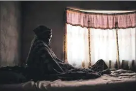  ??  ?? Painful past and present: Pakane Machete and Lesala Mpana (top), two survivors from Marikana’s ‘killing koppie’, pray at the spot where their comrades fell in 2012. Mary Segwegwe Langa (above) spent August 16 alone at her home in Tonga, near the...