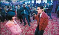  ??  ?? A man shares his feelings for a woman at a dating event for disabled people in Changsha, Hunan province, on Monday. The event attracted more than 300 disabled people and brought eight couples together.