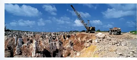  ?? AUSCAPE/UIG VIA GETTY IMAGES ?? A now-exhausted phosphate mining site on Nauru left a barren terrain of limestone pinnacles.