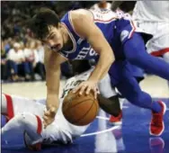  ?? LAURENCE KESTERSON — THE ASSOCIATED PRESS ?? Sixers forward Dario Saric (9) falls over Raptors guard Delon Wright (55) during the second half Thursday in Philadelph­ia. The Raptors won 114-109.