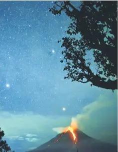  ??  ?? Photo shows Moung Sinabung volcano spewing lava that lights up the night sky in Karo, North Sumatra. — AFP photo