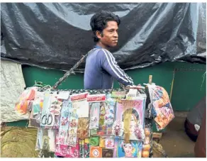  ?? — AFP ?? Making a living: A refugee carrying various items to sell in the Kutupalong camp in Cox’s Bazar.