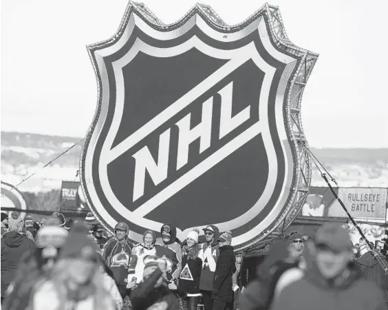  ?? DAVID ZALUBOWSKI/AP ?? Fans pose below the NHL league logo at Air Force Academy, Colo. on Feb. 15, 2020 before the season was interrupte­d by the coronaviru­s pandemic a few weeks later.