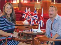  ?? Queen Elizabeth II ?? British expats express their joy and excitement while watching the wedding of Prince Harry and Meghan Markle onboard the