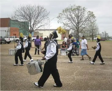  ?? Staff photo by Greg Bischof ?? ■ Pleasant Grove High School Marching Band proceeds before spectators Saturday during the 27th annual Twin Cities Black History Month Parade. The Twin Cities Black History Associatio­n held the parade after having to reschedule the event, planned for...