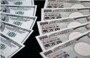  ??  ?? Mata wang yen mula mengatasi dolar AS selepas Bank of Japan berkata ia akan mengurangk­an pembelian bonnya.