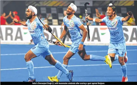  ??  ?? India's Simranjeet Singh (L) with teammates celebrate after scoring a goal against Belgium.