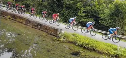  ?? AP PHOTO/ CHRISTOPHE ENA ?? The pack rides during the 14th stage of the Tour de France on Saturday with a finish on the Tourmalet pass in La Mongie, France.