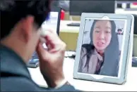  ?? ZHENG PENG / FOR CHINA DAILY ?? Linsey van Santen chats with her biological mother during a video call as her mother is overcome with emotion on Saturday.