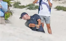  ?? AP PHOTO/FERNANDO LLANO ?? Rory McIlroy hits out of a bunker on the fifth hole at Albany Golf Club during the first round of the Hero World Challenge on Thursday in New Providence, Bahamas.