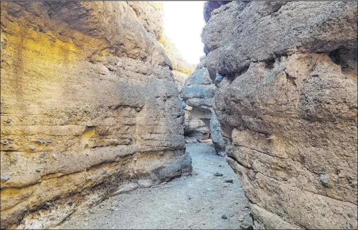  ?? Natalie Burt Las Vegas Review-Journal ?? Light and shadows are playful in the slot canyon found after a short hike up the wash along Owl Canyon Trail in Lake Mead National Recreation Area.