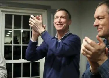  ?? ELISE AMENDOLA — THE ASSOCIATED PRESS FILE ?? In this file photo, former Colorado Gov. John Hickenloop­er, left, applauds at a campaign house party in Manchester, N.H. While the Democratic primary field has shifted left, polls show registered Democratic voters just want someone who can beat Donald Trump. That’s led to a potential contradict­ion being worked over by primary voters. Is the best route to victory to build a liberal movement to win converts or choose a more moderate candidate who can appeal to swing voters?