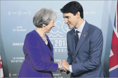  ?? PICTURE: PA WIRE. ?? ENTENTE: Canada Prime Minister Justin Trudeau meets with British Prime Minister Theresa May at the G7 Leaders Summit in La Malbaie, Quebec.