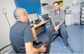  ??  ?? Dr Ian Smit, seen here talking with Lance at the Te Kao clinic, travels to Te Hapua every fortnight to treat patients.