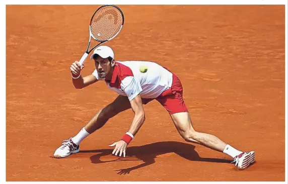  ?? — AP ?? Back to you: Novak Djokovic returning a shot to Kyle Edmund during the second round of the Madrid Open on Wednesday.