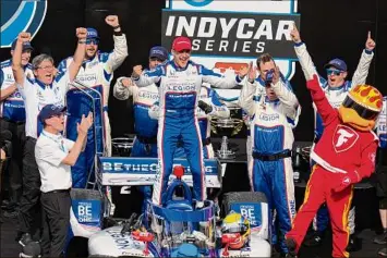  ?? Michael Conroy / Associated Press ?? Alex Palou, of Spain, center, celebrates after winning the IndyCar auto race at Indianapol­is Motor Speedway in Indianapol­is on Saturday. It was his first win in 11 tries at Indy.