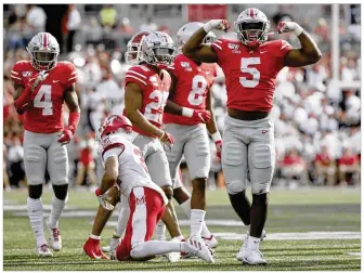  ?? BARBARA J. PERENIC / COLUMBUS DISPATCH ?? OSU linebacker Baron Browning celebrates after tackling Miami wide receiver Nick Manson on Saturday. The score at halftime was 49-5.