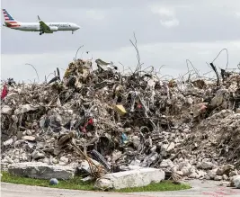  ?? MATIAS J. OCNER mocner@miamiheral­d.com ?? Debris from Champlain Towers South sits near Miami Internatio­nal Airport on July 10. The tragedy has moved Aventura to the verge of improving transparen­cy about its condos.