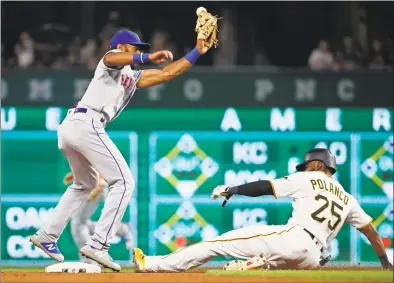  ?? Gene J. Puskar / Associated Press ?? The Pirates’ Gregory Polanco steals second as the throw from Mets catcher Devin Mesoraco gets away from shortstop Amed Rosario during the sixth inning in Pittsburgh on Saturday.