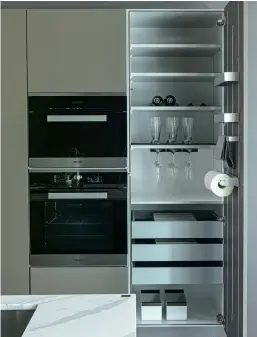 ??  ?? LEFT: SieMatic kitchens are not only big on style, they’re also big on function. This is clearly evident in the way they take their organizati­on systems with painstakin­g attention to detail. One of the most popular unique features that is present in every interior of a SieMatic cabinet is MultiMatic that gives 30% more storage space. To organize your items better, SieMatic also offers aluminum interior accessorie­s system.
RIGHT: In this Pure kitchen style, the connection SieMatic establishe­s with furniture and architectu­re is manifested through the way the look of this kitchen in Umbra & Lotus White Similaque Matte blends seamlessly with the interior, especially highlighti­ng its handleless design. Essentiall­y timeless, the unexpected layout of having a suspended breakfast nook in light smoked oak breathes a sense of modernity to the space.