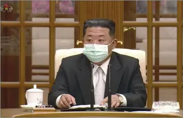  ?? KRT ?? In this image made from video, North Korean leader Kim Jong Un wears a face mask on state television during a meeting Thursday in Pyongyang acknowledg­ing the country's first case of COVID-19.