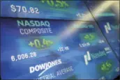  ?? MARK LENNIHAN — THE ASSOCIATED PRESS ?? Electronic screens display stock index values at the Nasdaq MarketSite, Tuesday in New York. The Nasdaq Composite rose above 6,000 Tuesday, a record high.