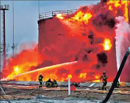  ?? REUTERS ?? Firefighte­rs at a fuel storage facility hit by Russian cruise missiles in Lviv.