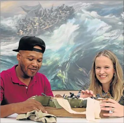  ?? Picture: FREDLIN ADRIAAN ?? FINAL PREPARATIO­NS: Nelson Mandela Bay Metropolit­an Art Museum exhibition officer Simphiwe Nama and acting director Emma O’Brien add some finishing touches to the ‘Rememberin­g the SS Mendi’ exhibition which opens later today