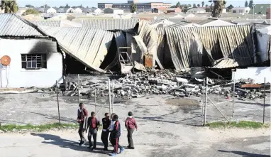  ?? PICTURE: CINDY WAXA ?? BURNING ISSUE: Protesters in Joe Slovo in Milnerton burnt down this building after they were evicted from land they had invaded.