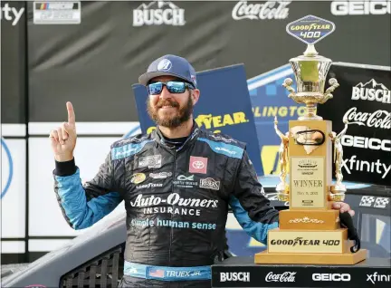  ?? TERRY RENNA — THE ASSOCIATED PRESS ?? Martin Truex Jr. stands with his trophy in Victory Lane after winning the NASCAR Cup Series auto race at Darlington Raceway, Sunday, May 9, 2021, in Darlington, S.C.