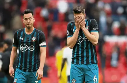 ??  ?? No Xmas cheer: Southampto­n’s Wesley Hoedt (right) and Maya Yoshida looking dejected after the match. — Reuters