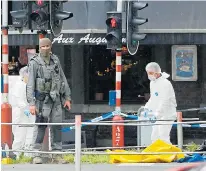  ??  ?? Forensic team at the scene of Tuesday’s shootings