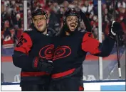  ?? KARL B DEBLAKER — THE ASSOCIATED PRESS ?? The Hurricanes' Paul Stastny, left, celebrates with Jalen Chatfield after scoring against the Capitals on Saturday.