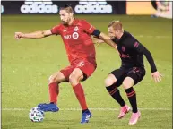  ?? Jessica Hill / Associated Press ?? Toronto FC’s Omar Gonzalez, left, controls the ball as New York Red Bulls’ Daniel Royer defends earlier this month at Rentschler Field.