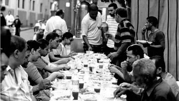  ?? — Reuters photo ?? Muslims eating meals prepared by Coptic Christians during Ramadan in Cairo, Egypt.