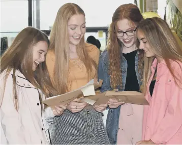  ??  ?? Pupils at St Bede’s Catholic Comprehens­ive School opening their GCSE results envelopes.