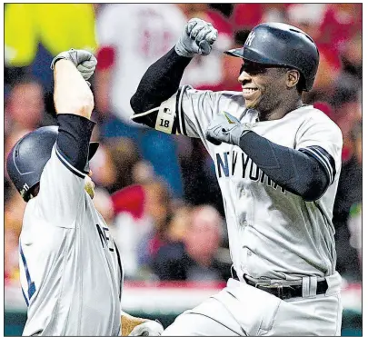  ?? AP/DAVID DERMER ?? Didi Gregorius (right) of the New York Yankees is congratula­ted by teammate Brett Gardner after hitting his second home run during the Yankees’ 5-2 victory over the Cleveland Indians in Game 5 of the American League division series Wednesday night. The...
