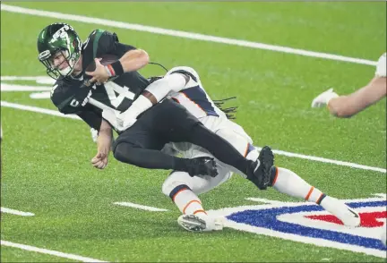  ?? JOHN MINCHILLO — ASSOCIATED PRESS ?? Jets quarterbac­k Sam Darnold is sacked by the Broncos’ A.J. Johnson during the first half of their game Thursday night in East Rutherford, N.J.