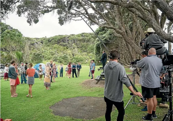  ??  ?? There’s a crowd of people who look like they’ve sprung straight out Woodstock, as Murray Keane directs on location in Huia.