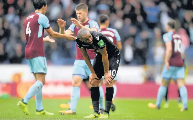  ?? Laurence Griffiths ?? Andros Townsend of Palace looks dejected as Burnley players celebrate their victory at Turf Moor