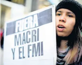  ?? AP ?? A woman holds a sign reading in Spanish ‘Macri and IMF leave’ during a protest against the economic policies and austerity measures put in place by the administra­tion of President Mauricio Macri, in Buenos Aires, Argentina, Thursday, August 22, 2019.