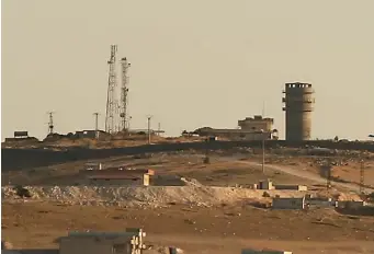  ?? AP ?? In this photo taken from the Turkish side of the border between Turkey and Syria, a US forces outpost is seen on a hilltop outside Kobani, Syria. The outpost was bracketed by artillery fire at the weekend.