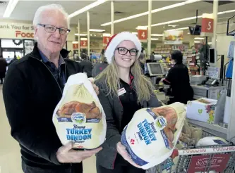  ?? JESSICA NYZNIK/EXAMINER ?? Ross Bletsoe, co-owner of Lakefield Foodland, and Katelyn Condon get ready to give away turkeys to Lakefield residents in need at the Queen St. grocery store on Wednesday. The Bletsoe family bought 150 turkeys to hand out this year. They started the...