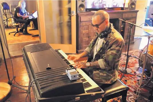  ?? COURTESY OF KIRK MATTHEWS ?? Songwriter Kirk Matthews performs at “Rio Grande Live,” which is filmed at Rio Grande Studios in Albuquerqu­e. In the background is Kenny Riley of Rio Grande Studios.