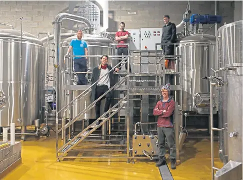  ??  ?? CHEERS: Vault City Brewing co-founder Steven Smith-hay, top right, with staff at the firm’s Edinburgh premises.